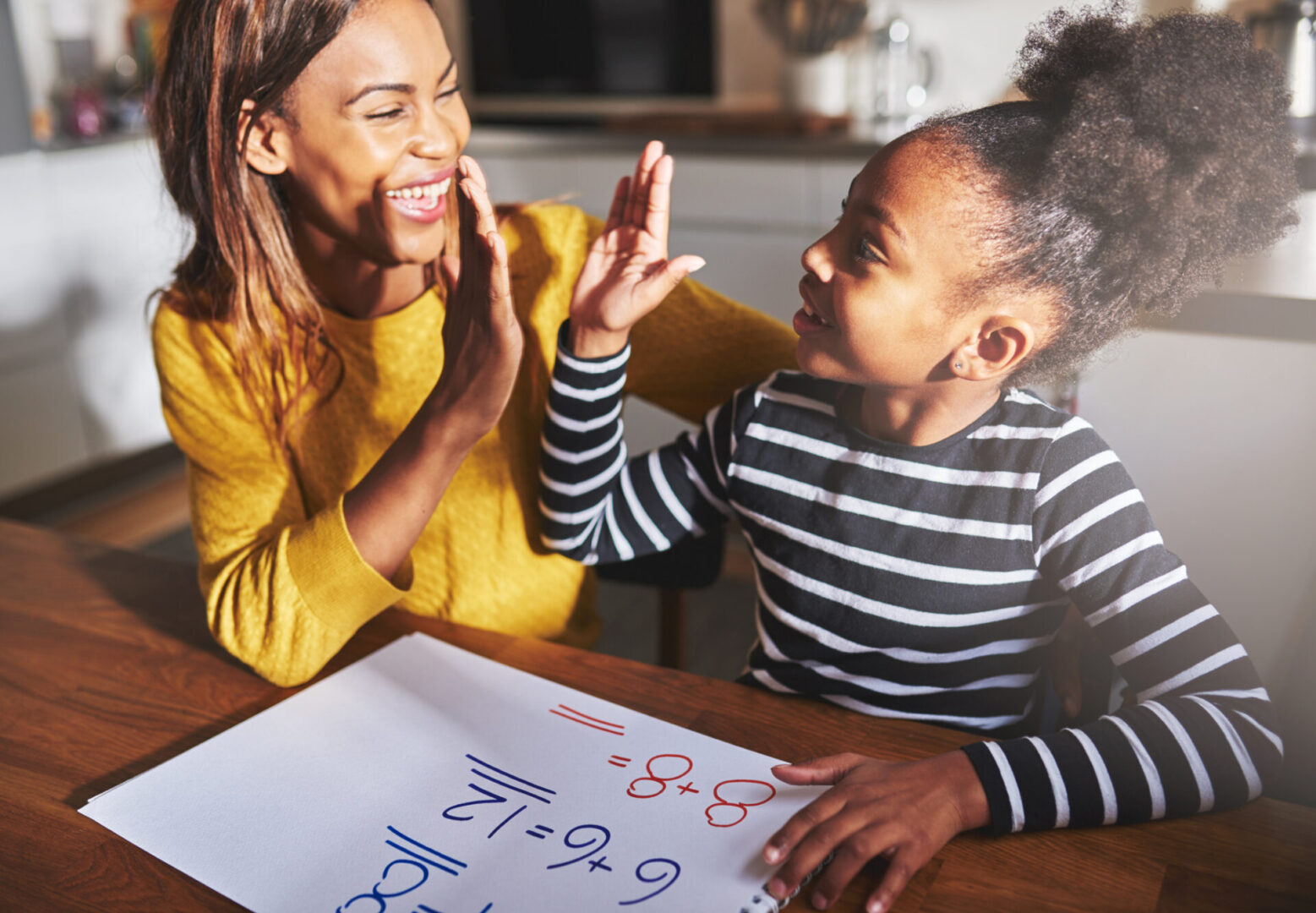 Learning to calculate, high five success, black mother and child