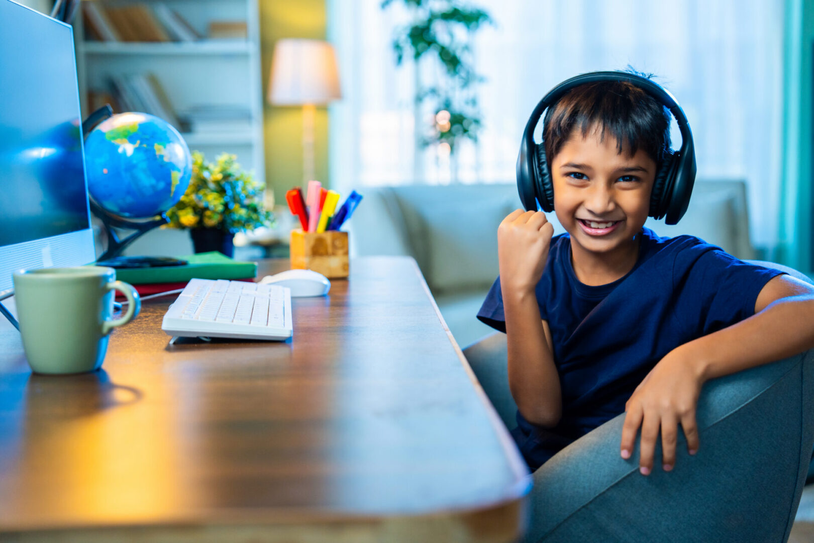 Studious Indian Asian Boy Attending Online Class at Home Using Computer, Learning Virtually and Communicating with Teacher, Highlighting Modern Education, E-Learning, and Technology in Daily Life